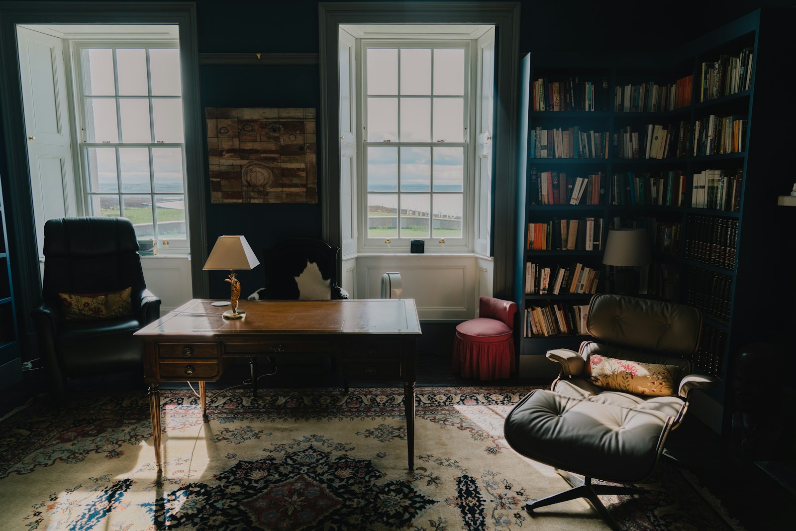 A living room filled with furniture and a book shelf